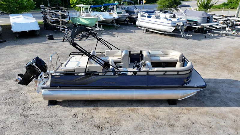 Slide: The Image of 2025 Tahoe Pontoon Sport 85 Versatile Rear Bench in a boatyard setting. - 3