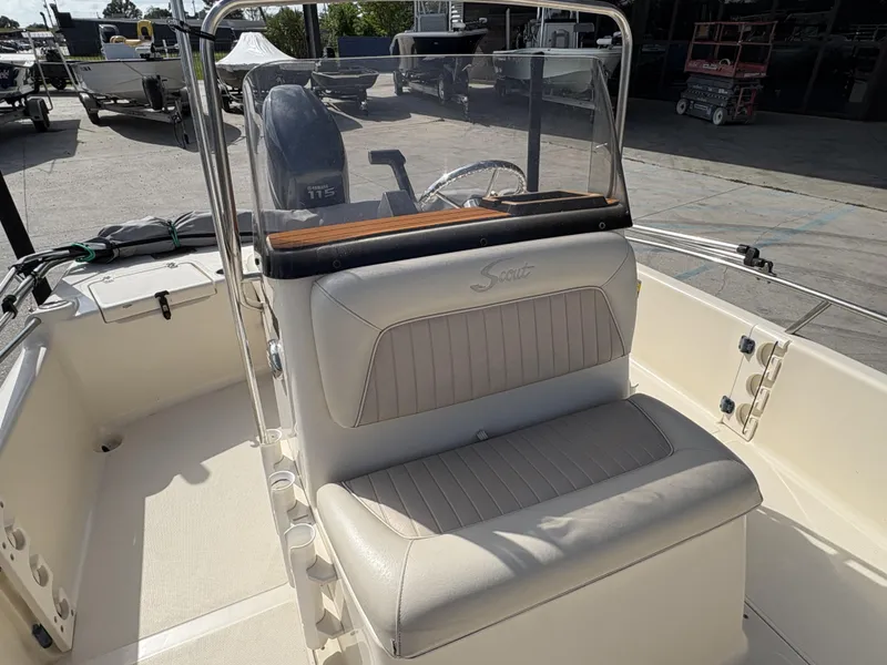 Slide: The Image of 2005 Scout 17 boat interior with cushioned seating and Yamaha 115 engine. - 12