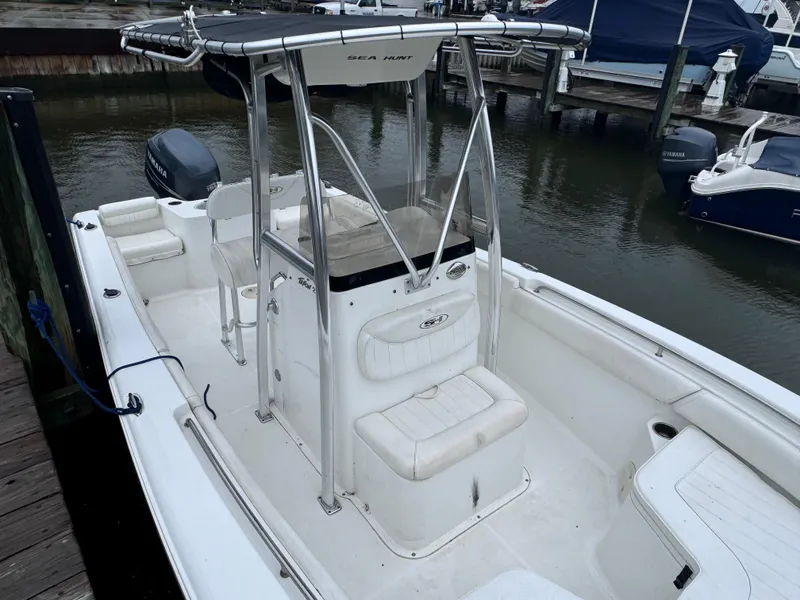 Slide: The Image of 2011 Sea Hunt Triton 225 boat docked, featuring center console and seating. - 14