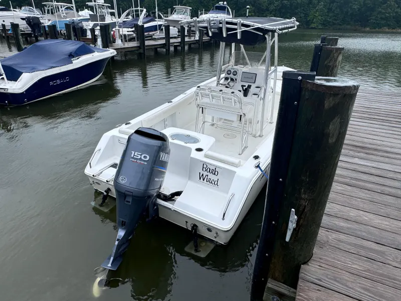 Slide: The Image of 2011 Sea Hunt Triton 225 boat docked with Yamaha 150 outboard motor. - 4