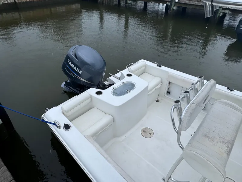 Slide: The Image of 2011 Sea Hunt Triton 225 boat with Yamaha outboard motor docked in calm waters. - 7
