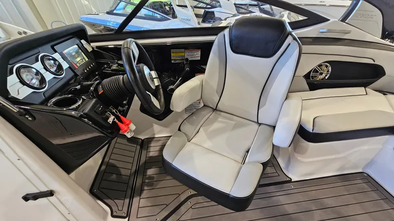 Slide: The Image of 2017 Yamaha Boats 212X cockpit with steering wheel and comfortable seating. - 10