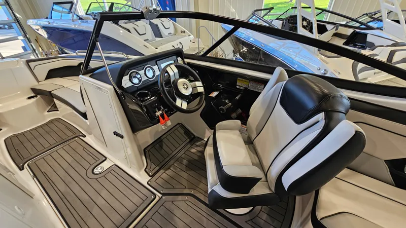 Slide: The Image of 2017 Yamaha Boats 212X interior with sleek dashboard and comfortable seating. - 11