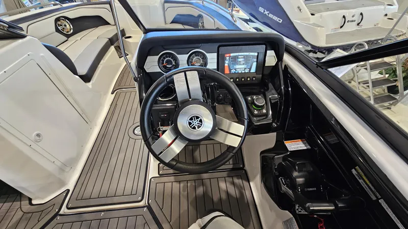 Slide: The Image of 2017 Yamaha Boats 212X cockpit with steering wheel and dashboard controls. - 12