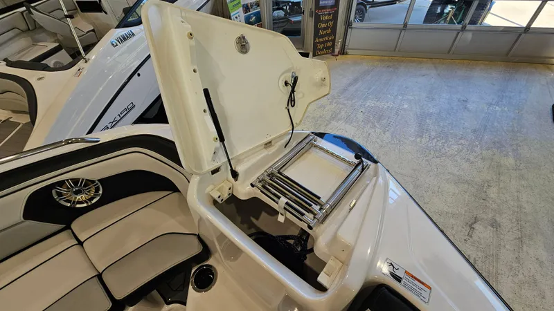 Slide: The Image of 2017 Yamaha Boats 212X with open storage compartment and seating area. - 18