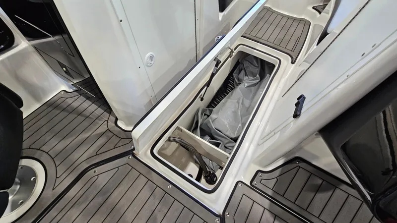Slide: The Image of 2017 Yamaha Boats 212X interior storage compartment with sleek, modern design and durable flooring. - 19