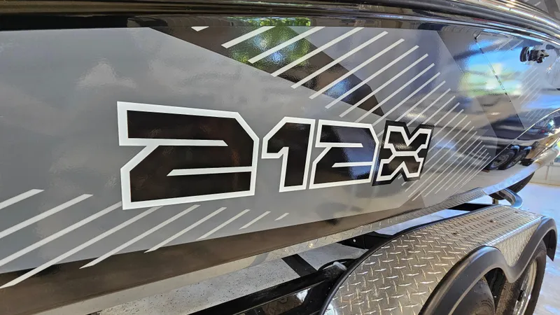 Slide: The Image of 2017 Yamaha Boats 212X side view with bold graphics on trailer. - 24