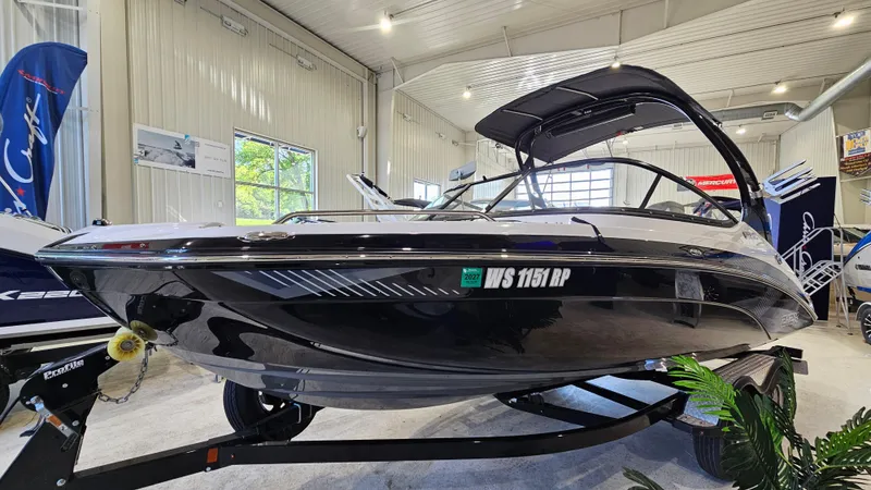 Slide: The Image of 2017 Yamaha Boats 212X in showroom, sleek black design, on trailer. - 4