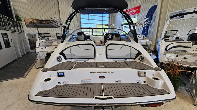 Slide: The Image of 2017 Yamaha Boats 212X in showroom, rear view with seating and swim platform. - 5