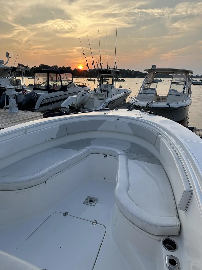 Slide: The Image of 2009 Edgewater 318CC boat docked at sunset with other boats in the background. - 10