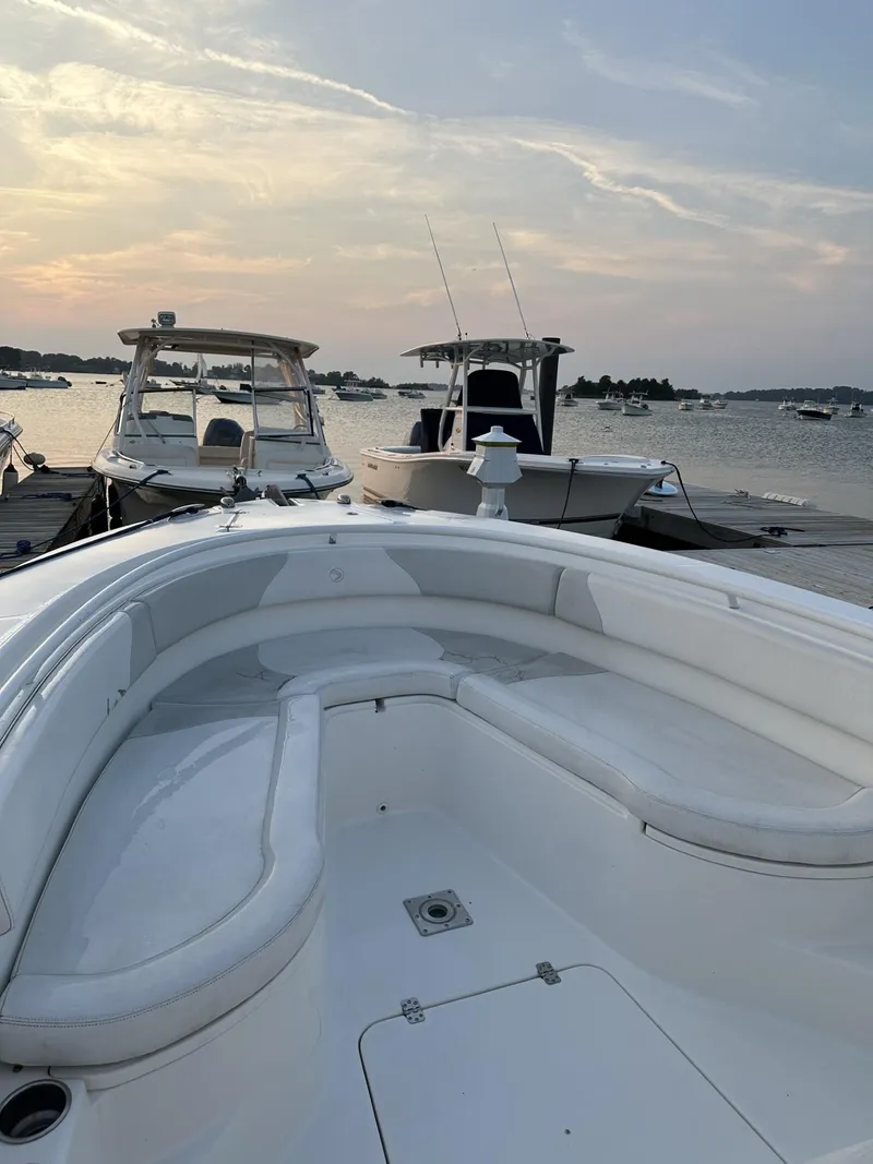 Slide: The Image of 2009 Edgewater 318CC boat docked at sunset with other boats in the background. - 11