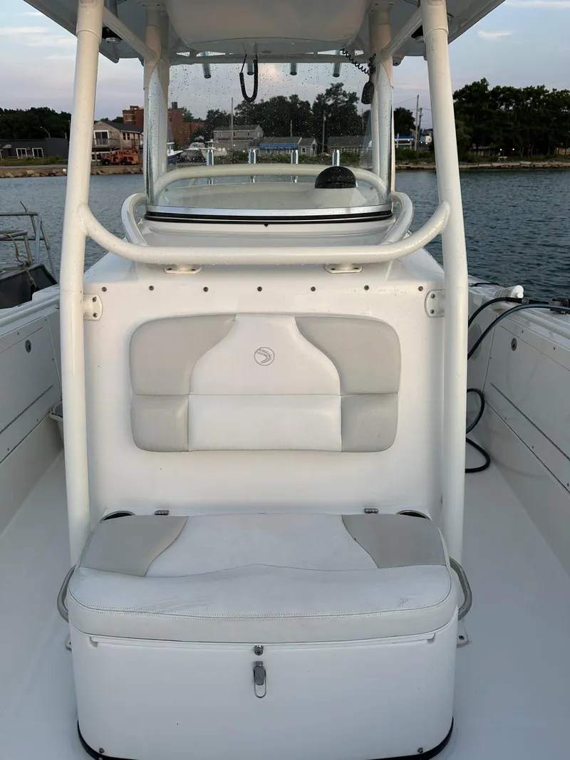 Slide: The Image of 2009 Edgewater 318CC boat interior with seating, helm, and water view. - 12