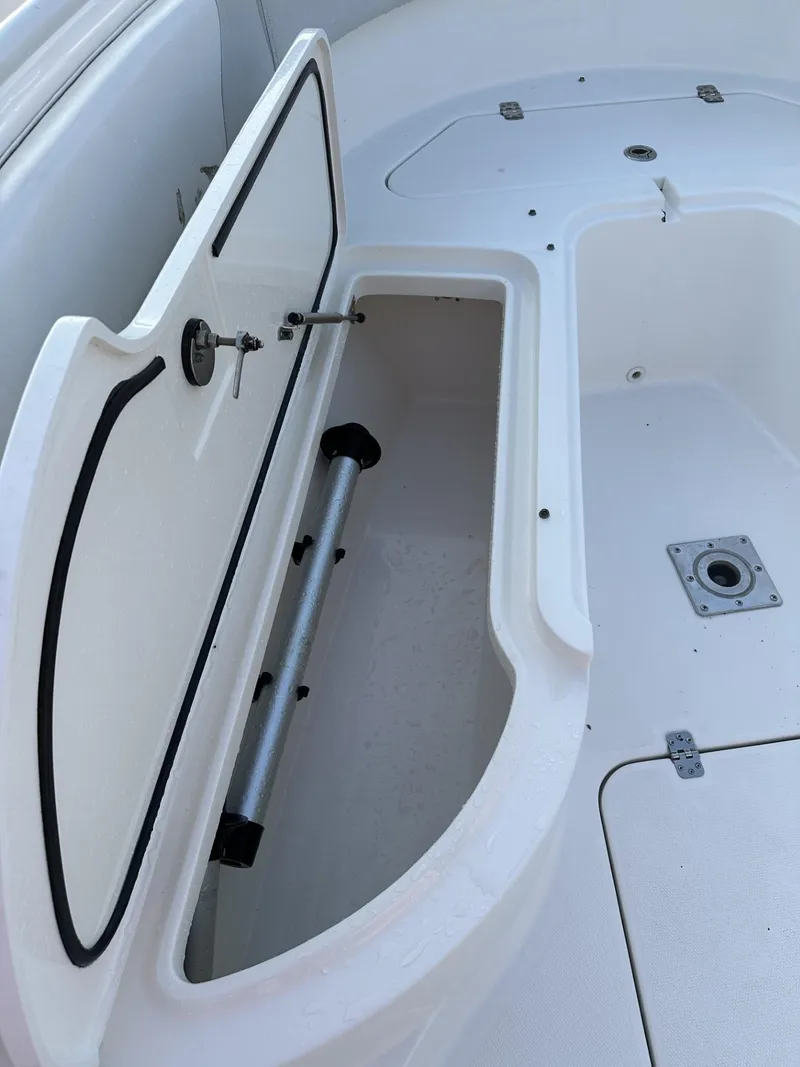 Slide: The Image of 2009 Edgewater 318CC boat storage compartment with open hatch and secure latch. - 13