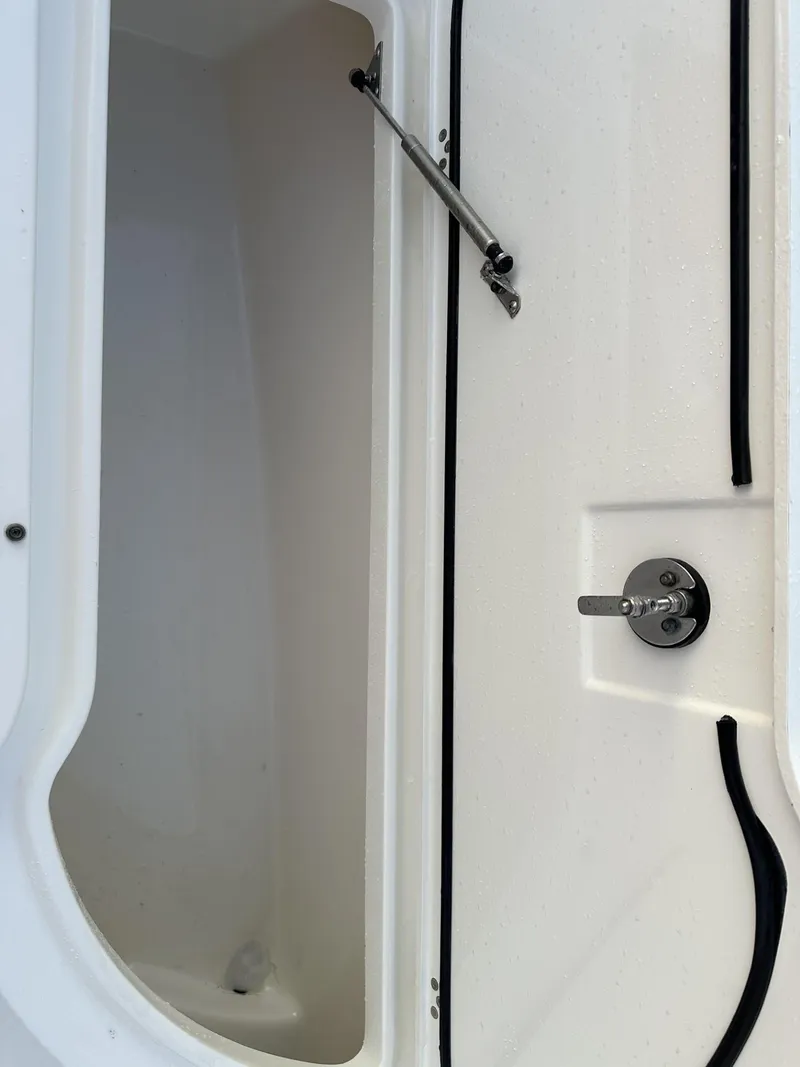 Slide: The Image of 2009 Edgewater 318CC boat storage compartment with latch and hydraulic support. - 14