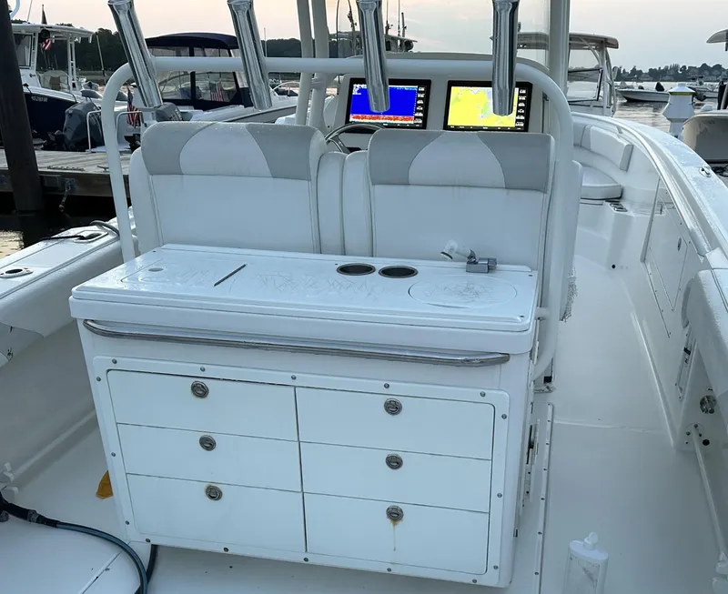 Slide: The Image of 2009 Edgewater 318CC boat interior with dual screens and storage drawers. - 21