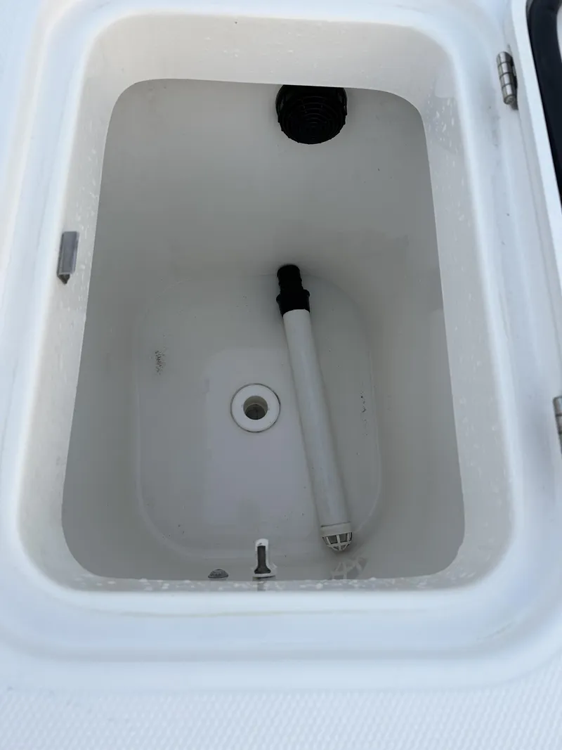 Slide: The Image of 2009 Edgewater 318CC boat compartment with drain and pipe. - 23