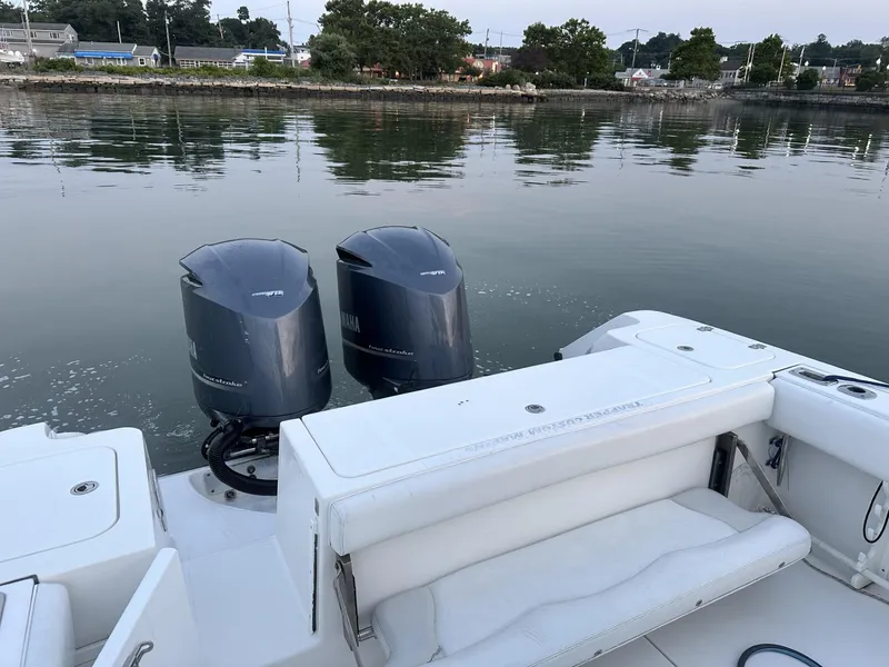 Slide: The Image of 2009 Edgewater 318CC boat with dual outboard motors on calm water. - 24