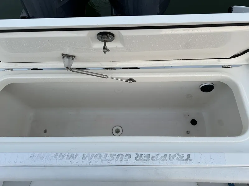 Slide: The Image of Open storage compartment on a 2009 Edgewater 318CC boat, featuring a clean, spacious interior. - 25