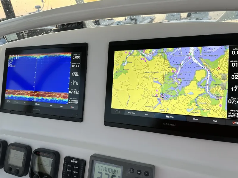 Slide: The Image of 2009 Edgewater 318CC boat dashboard with navigation and sonar displays. - 27