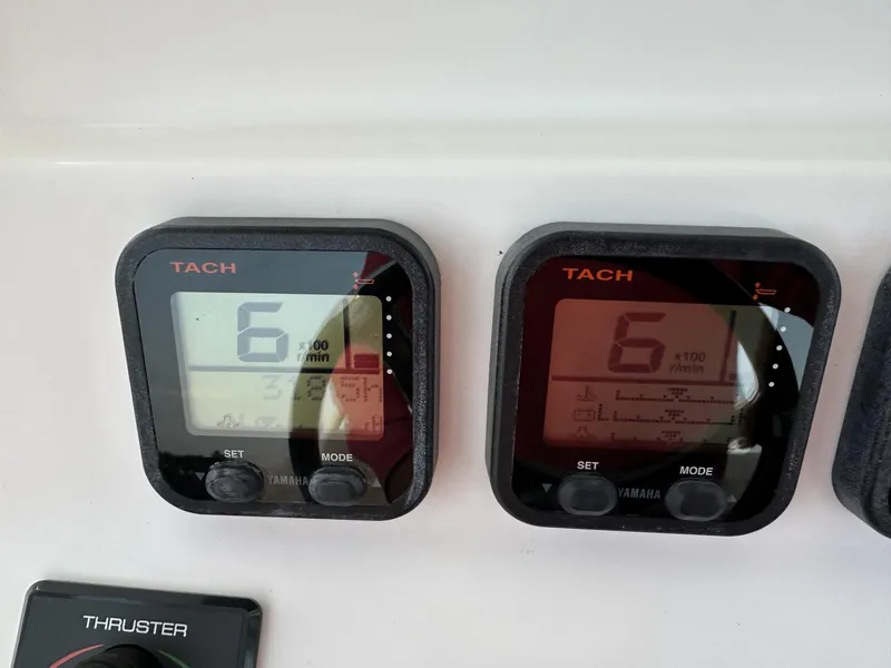 Slide: The Image of Tachometer displays on 2009 Edgewater 318CC boat dashboard, showing RPM readings. - 29