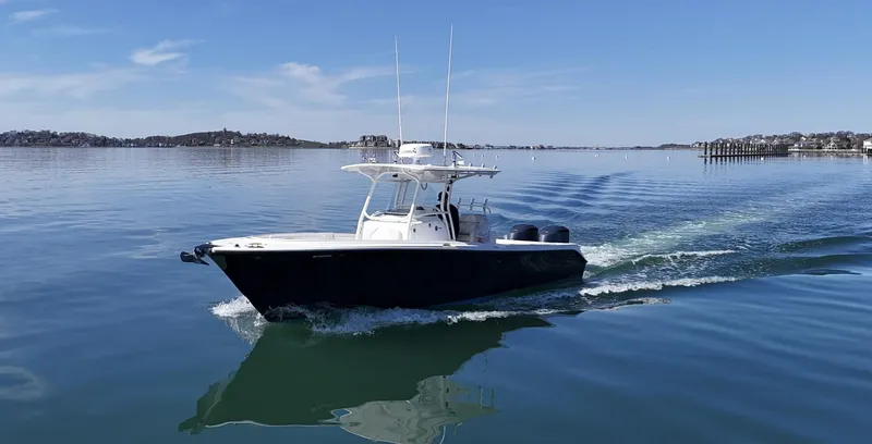 Slide: The Image of 2009 Edgewater 318CC boat cruising on calm water under a clear blue sky. - 3