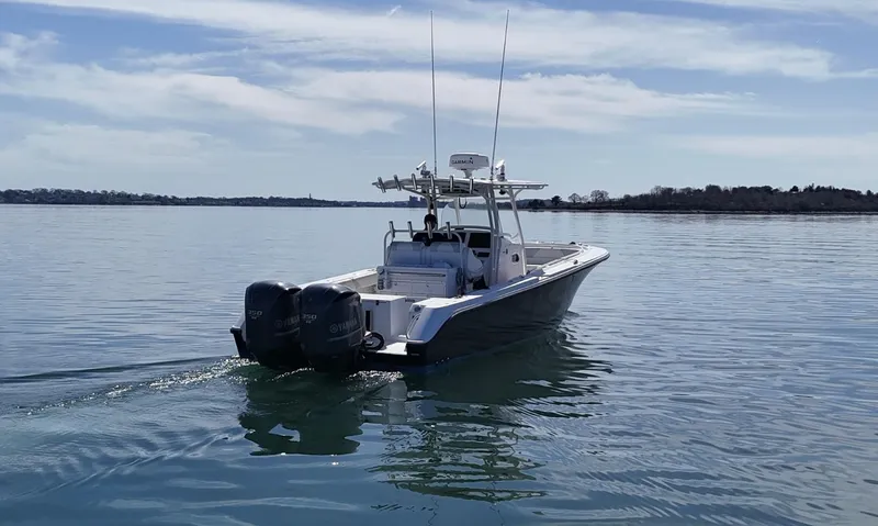 Slide: The Image of 2009 Edgewater 318CC boat cruising on calm waters under a clear sky. - 8