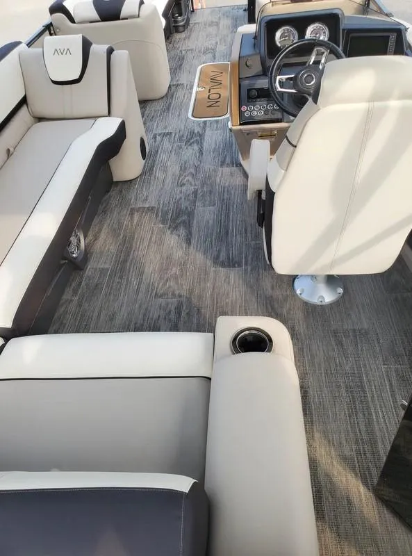 Slide: The Image of 2024 Avalon Catalina Entertainer Funship interior with plush seating and modern dashboard. - 10