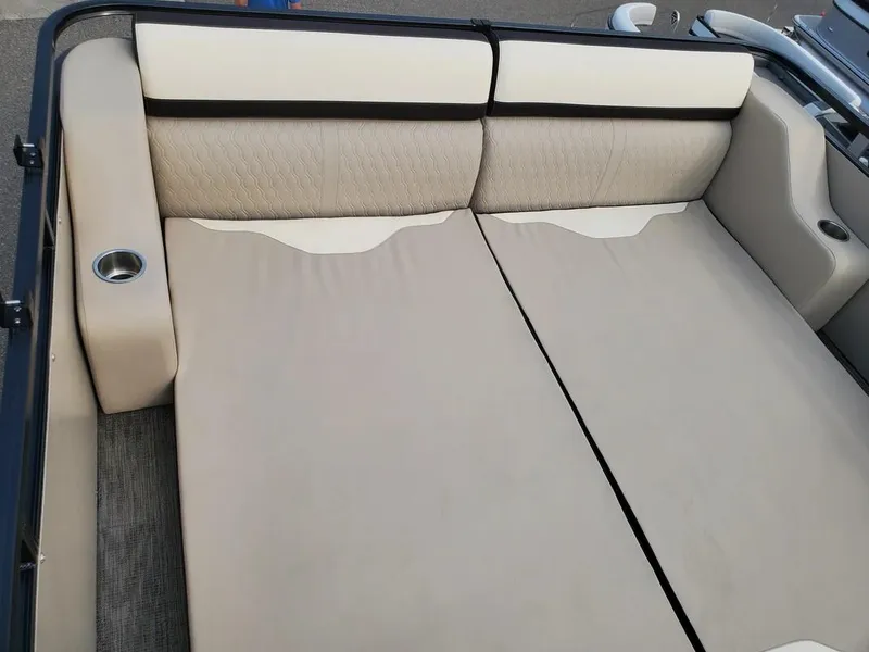 Slide: The Image of 2024 Avalon Catalina Entertainer Funship's spacious beige seating area with cup holders. - 12