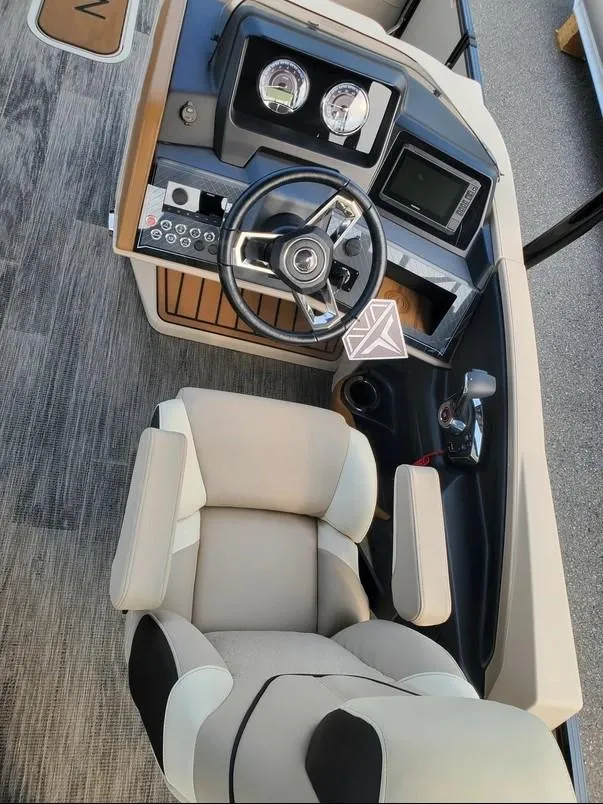 Slide: The Image of 2024 Avalon Catalina Entertainer Funship helm with modern controls and comfortable captain's chair. - 17