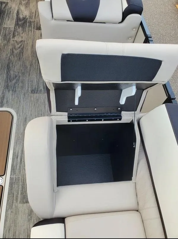 Slide: The Image of 2024 Avalon Catalina Entertainer Funship seat storage compartment open, showcasing interior space. - 20