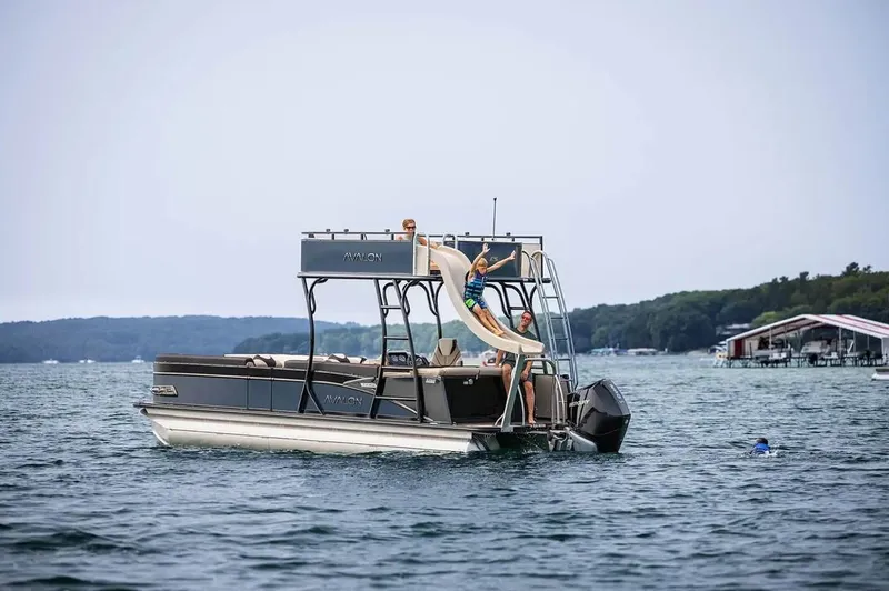 Slide: The Image of 2024 Avalon Catalina Entertainer Funship with slide on a lake, featuring passengers enjoying the water. - 4