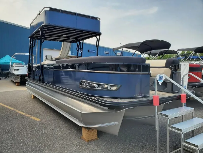 Slide: The Image of 2024 Avalon Catalina Entertainer Funship pontoon boat displayed outdoors. - 5