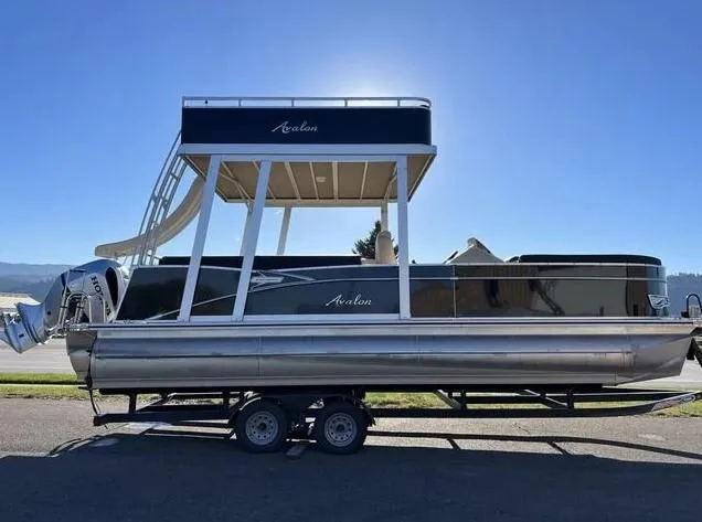 Slide: The Image of 2024 Avalon Catalina Entertainer Funship pontoon boat with slide, parked on trailer. - 7