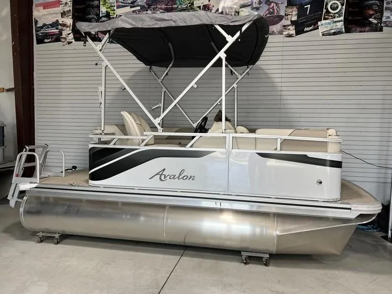 Slide: The Image of 2024 Avalon Cruise or Fish pontoon boat with canopy in showroom. - 10