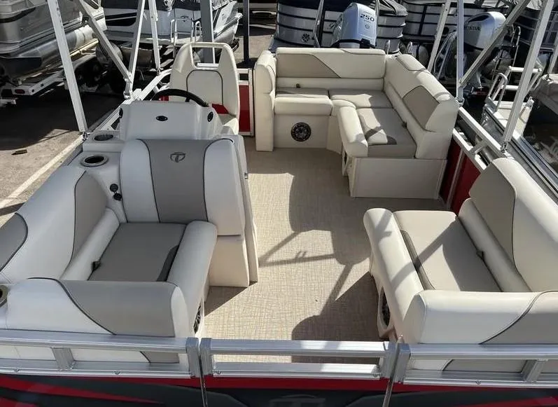 Slide: The Image of 2024 Avalon Cruise or Fish pontoon boat interior with plush seating and steering console. - 12