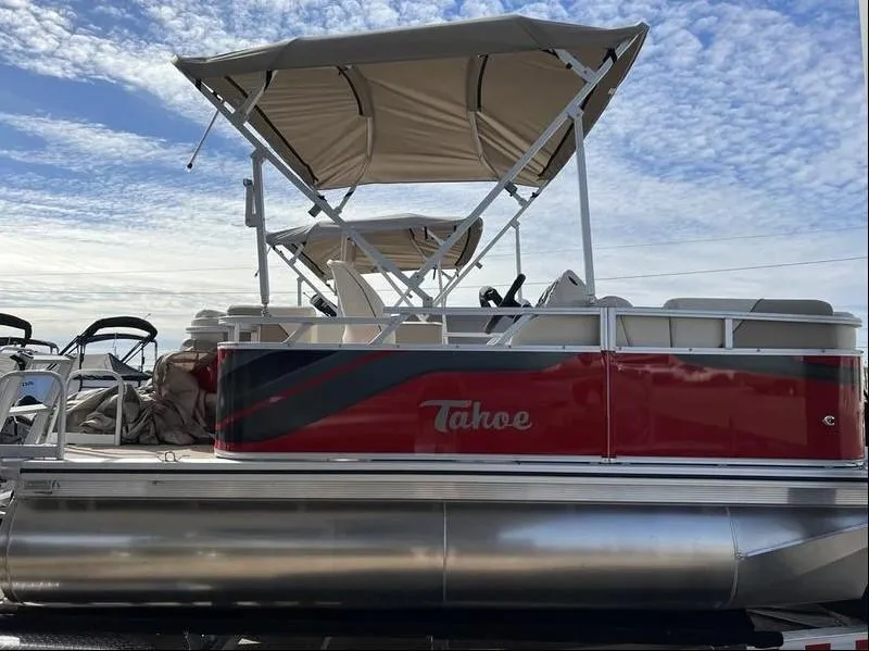 Slide: The Image of 2024 Avalon Cruise or Fish pontoon boat with red and gray design, featuring a canopy. - 14