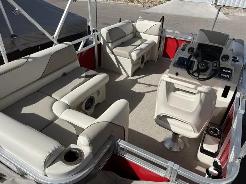 Slide: The Image of 2024 Avalon Cruise or Fish boat interior with beige seating and steering console. - 16