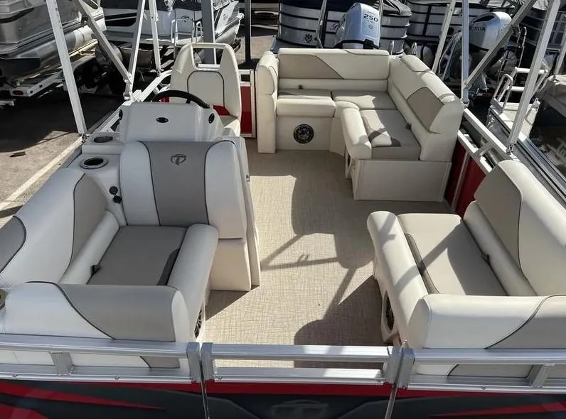 Slide: The Image of 2024 Avalon Cruise or Fish pontoon boat interior with beige seating and steering console. - 17