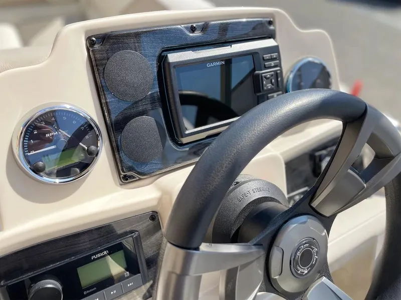 Slide: The Image of 2024 Avalon Cruise or Fish dashboard with Garmin GPS and steering wheel. - 7
