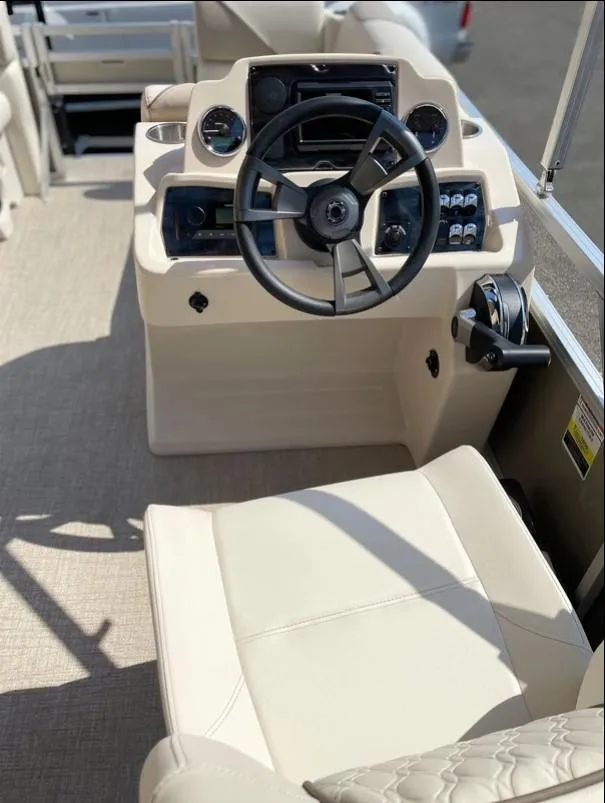 Slide: The Image of 2024 Avalon Cruise or Fish boat helm with steering wheel and control panel. - 8