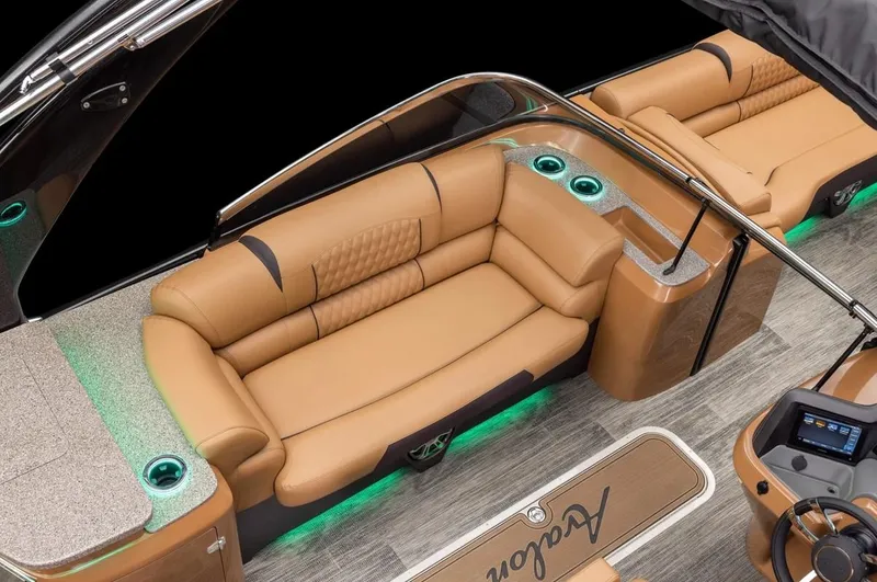 Slide: The Image of 2024 Avalon Excalibur LTD Elite Windshield boat interior with luxurious tan seating and ambient lighting. - 29