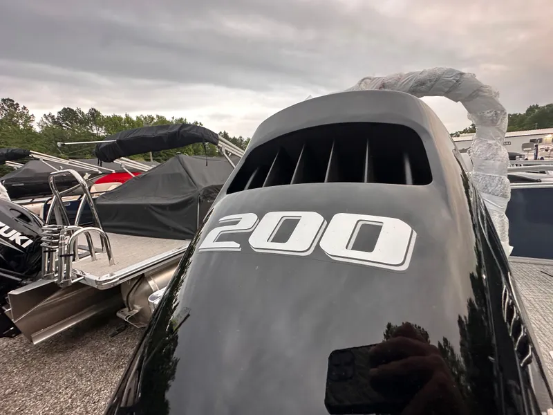 Slide: The Image of 2025 Tahoe Pontoon LTZ Versatile Rear Lounger with 200 HP engine, parked outdoors. - 13