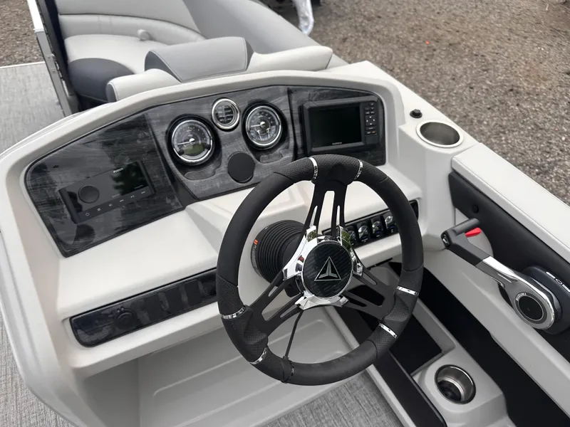 Slide: The Image of 2025 Tahoe Pontoon LTZ Versatile Rear Lounger dashboard with modern steering and controls. - 2