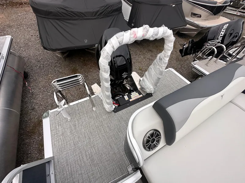 Slide: The Image of 2025 Tahoe Pontoon LTZ Versatile Rear Lounger with covered outboard motor and spacious deck. - 5