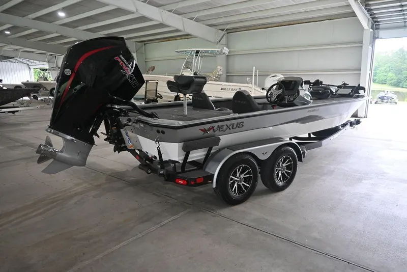 Slide: The Image of 2024 Vexus AVX2080 boat in a showroom, featuring a sleek design and powerful outboard motor. - 8