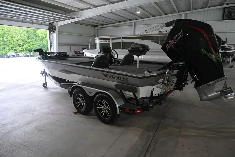 Slide: The Image of 2024 Vexus AVX2080 boat in a garage, featuring a sleek design and powerful engine. - 9