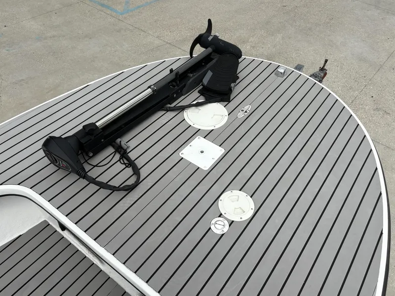 Slide: The Image of 2004 Custom Mitizi Skiff 17 boat deck with trolling motor and hatches. - 10