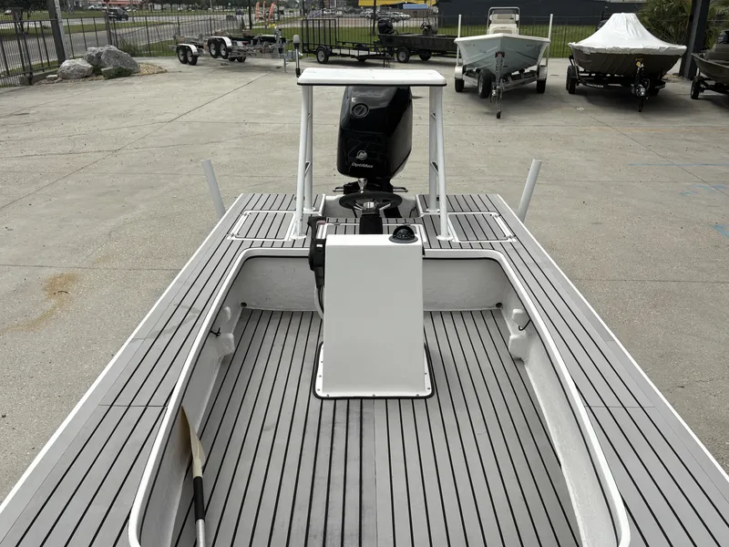 Slide: The Image of 2004 Custom Mitizi Skiff 17 boat with sleek deck design and central console. - 11