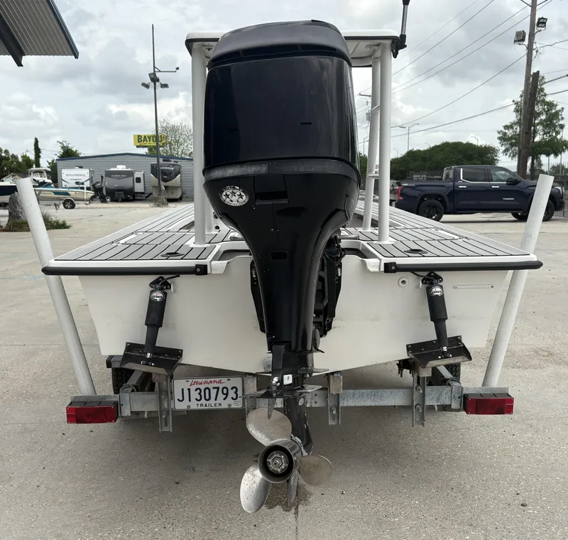 Slide: The Image of Rear view of a 2004 Custom Mitizi Skiff 17 boat on a trailer. - 3