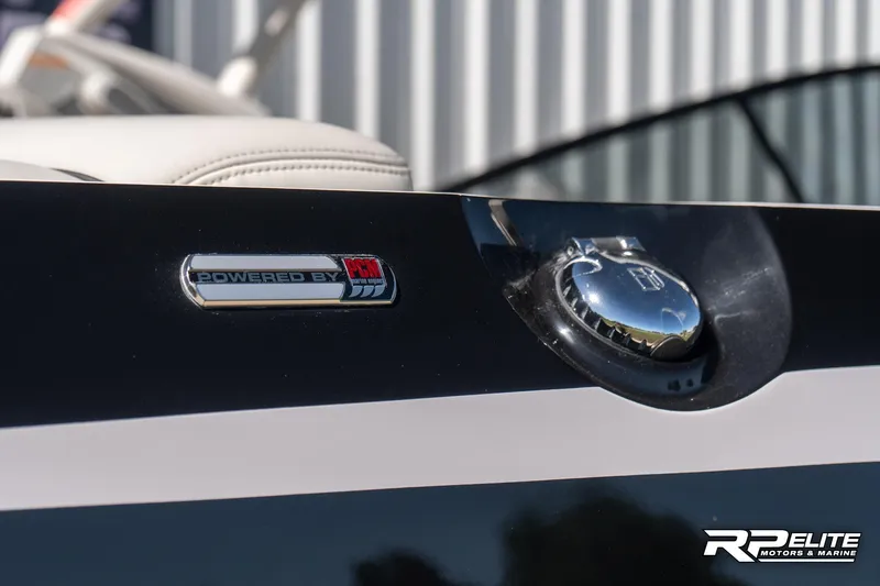 Slide: The Image of 2014 Nautique Super Air Nautique 230 fuel cap and "Powered by" badge detail. - 12